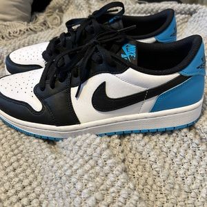Black, blue, and white low top Jordan 1s
